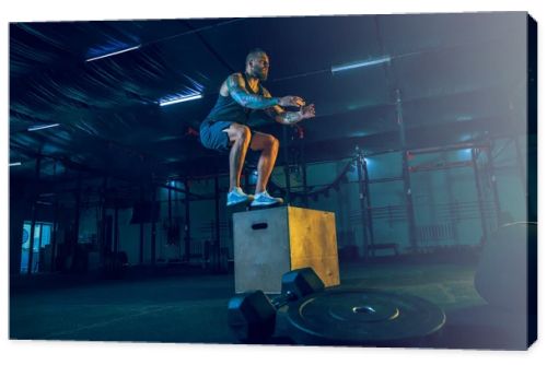 Young healthy man athlete doing exercise in the gym