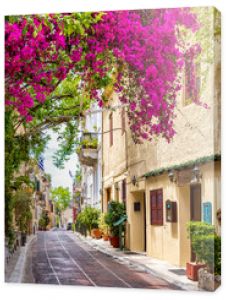 Beautiful view to the little streets of the old town Plaka of Athens, Greece with colorful houses and blooming bougainvillea flowers