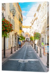 A picturesque street through the old town center of Antibes, France, in the Cote d'Azur, French Riviera region along the Mediterranean Sea.