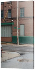 Vintage street scene with abandoned red brick warehouses in a depressed industrial area