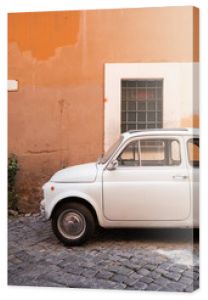 Vintage car parked in a cozy street in Trastevere, Rome, Italy, Europe.