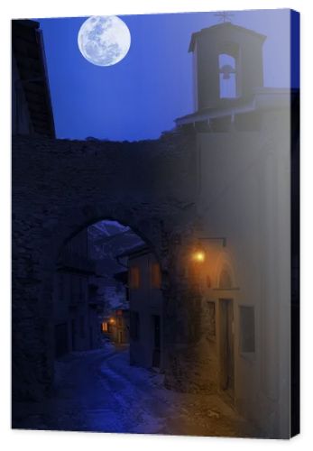 Night view of narrow street in small town.