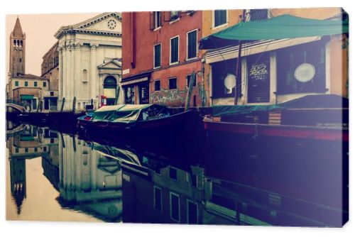 beautiful canal with boats in Venice