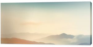 Dreamy mountains with autumn background during sunset or sunrise. Elegant and minimalistic style wallpaper with copy space in orange, yellow colors.