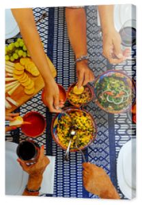 Male and female serving food on table during weekend