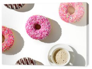 A cup of coffee and a variety of donuts on a white background. Flat lay composition with coffee and donuts.