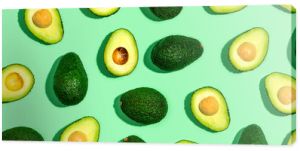 Fresh avocado pattern on a green background flat lay