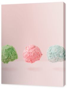 Ice cream scoops against pastel pink background. Minimal summer food concept.