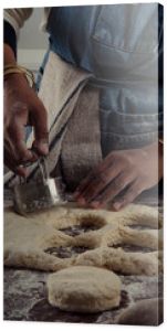 Biscuit cutter being used on dough