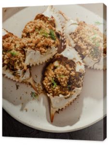 Close up of stuffed blue crabs on white plate