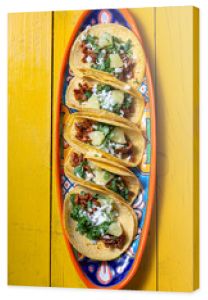 Mexican background with tacos al pastor and mexican sauces. Yellow wooden background, copy space, top view