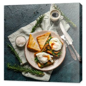 Plate with tasty egg Benedict and cup of coffee on black background