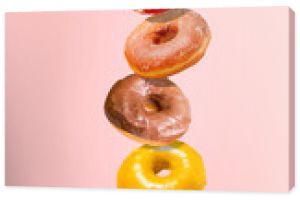 Levitating donuts isolated on a pink background. Modern food concept. Advertising for pastry shops, cafes.