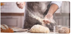 hands of baker's male knead dough