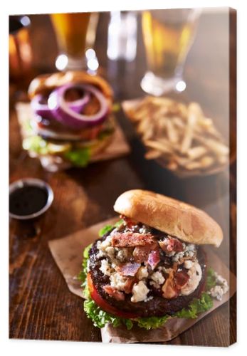 Two gourmet cheeseburgers with beer
