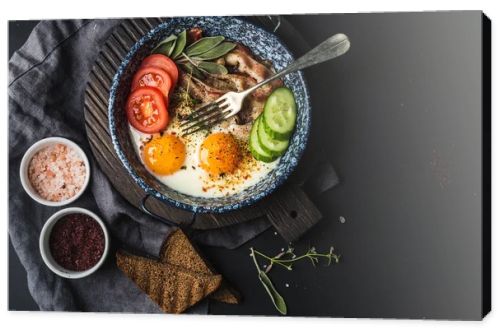 Pan of fried eggs with bacon