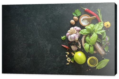 Herbs and spices on black stone table