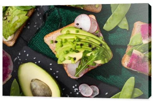 top view of vegetarian sandwiches with fresh vegetables green cloth