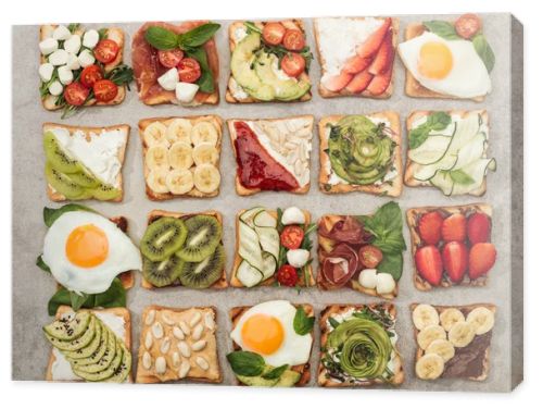 Top view of toasts with fried eggs, cut vegetables and fruits on textured surface