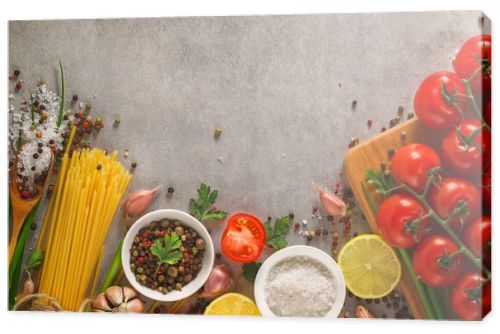 Italian food background on stone table. Macaroni, basil and vegetables.