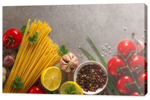 Italian food background on stone table. Macaroni, basil and vegetables.