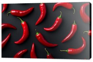 Top view of red chili peppers pattern on a black background resembling a chili wallpaper